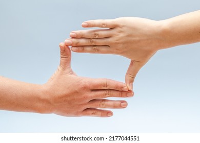 Two hands gesturing on a blue background