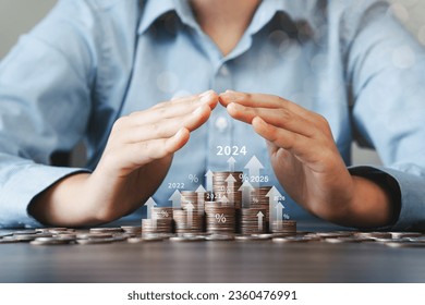 Two hands giving stacks of silver coins with 2024 trading chart, financial concept and stock growth, financial investment business with up arrow and percentage symbol Finance increases interest rates