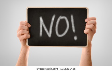 Two hands gripping tightly blackboard horizontally and no message isolated gray gradient background  Horizontal composition