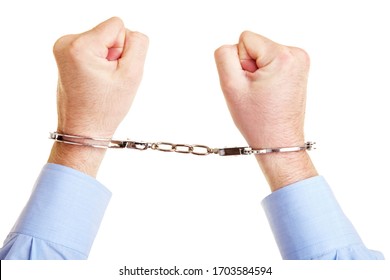 Two Hands In Handcuffs Are Clenched Into Fists