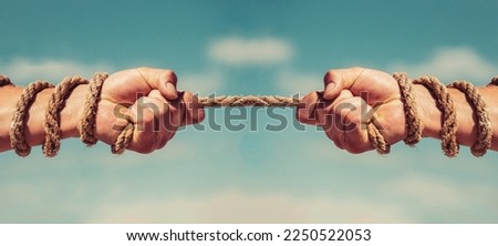 Two hands, helping hand, arm, friendship. Rope, cord. Rescue, help helping gesture or hands Conflict tug of war
