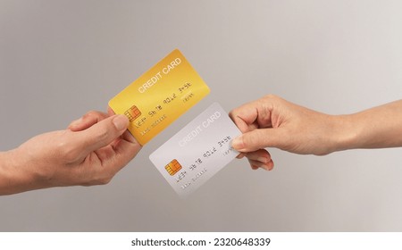 Two hands is hold black and gold credit card on white background.	 - Shutterstock ID 2320648339