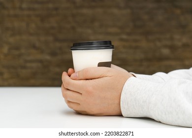 Two Hands Hold Coffee Cup. Warming Hands On Paper Coffee Hot Cup Mockup, Hugging Warm Mug In Cafe With Copy Space Side View