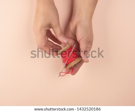 Similar – wooden reel with red wool thread