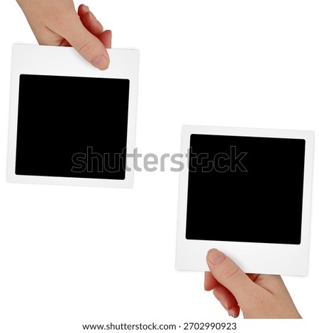 Two hands holding blank empty instant photo frames with white borders against a clean isolated white background showcasing a square film format ready for your personal pictures or creative design projects captured with bright soft studio lighting illumination