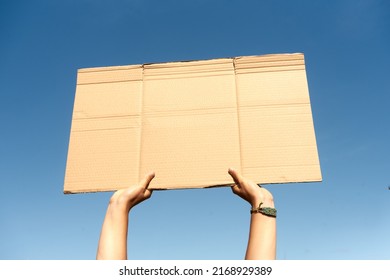 Two Hands Holding A Cardboard Sign With No Content.