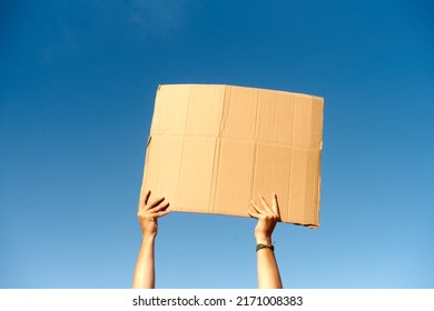 Two Hands Holding A Cardboard Sign With No Content.