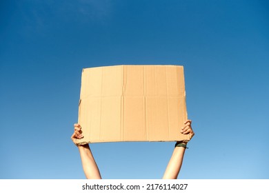 Two Hands Holding A Cardboard Sign With No Content.