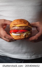 Two Hands Holding Delicious Beef Burger. Gourmet Conception. Concept Of Tasty Food With Delicious Burger