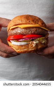 Two Hands Holding Delicious Beef Burger. Gourmet Conception. Concept Of Tasty Food With Delicious Burger