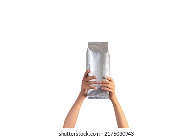 Two Hands holding up a foil bag isolated on white background. - Shutterstock ID 2175030943