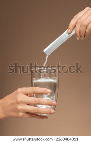 two hands holding a glass of water