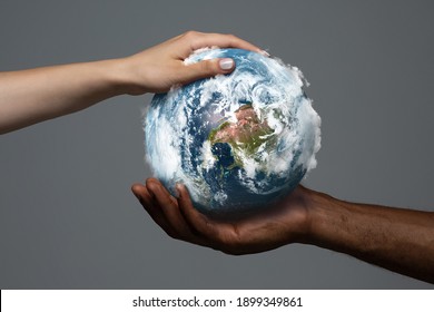 Two hands holding planet Earth, close up. Environment save, taking care of nature and ecology, supporting hands concept. Globe woldwide protection, traveling and protecting of human's home.