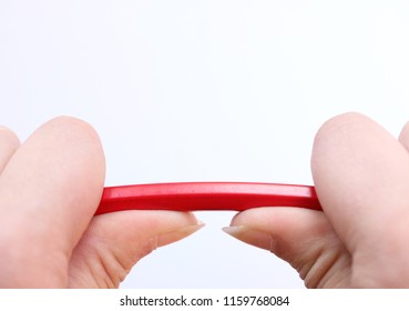 Two Hands Holding A Red Pencil About To Snap Under The Pressure. Concept Of Stress, Anger Management, Pressure In The Work Place, Parenting And Breakdown.