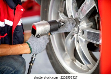 Two Hands Holding A Wind Instrument Remove The Wheel Nuts