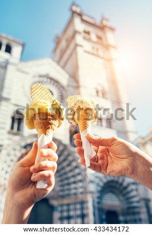 Two hands with ice cream on the San Lorenco Cathedral  background