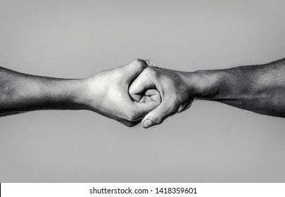 Two hands, isolated arm, helping hand of a friend. Rescue, helping hand. Male hand united in handshake. Man help hands, guardianship, protection. Black and white. - Shutterstock ID 1418359601