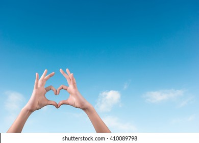 Two Hands Making A Heart Shape In The Blue Sky