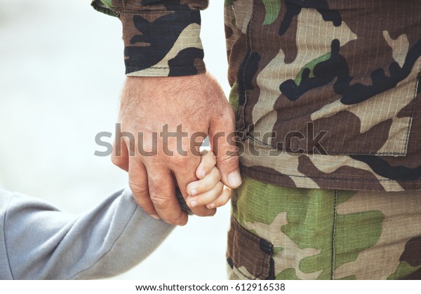 Two hands  of one family - father and child\
together. The concept of family unity protection support prosperity\
love and parental\
happiness.