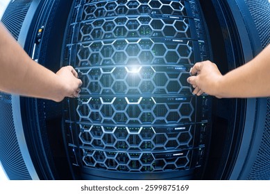 Two hands open a server rack in a modern data center, revealing advanced technology for data storage and management, highlighting the importance of connectivity.