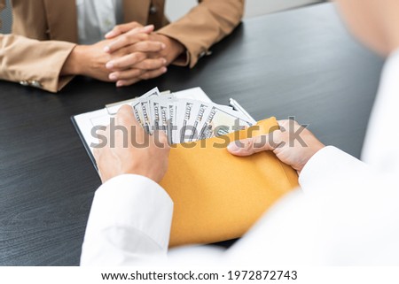 two hands passing bills making agreement to initiate the new business.
