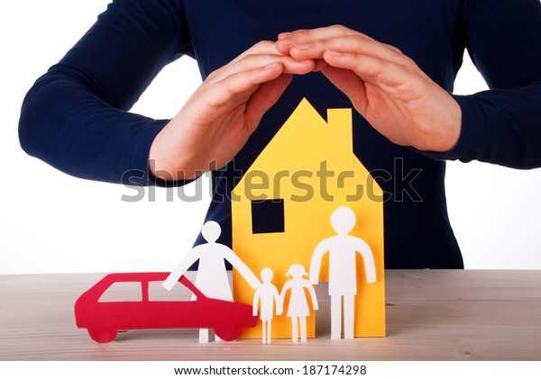 Two Hands are Protecting a Family infront of its
House with their Car,
Isolated