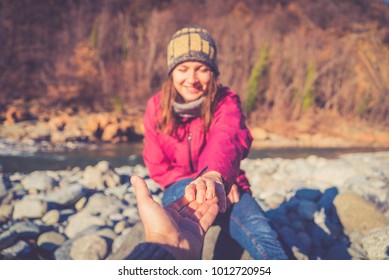 Two hands reaching toward each other. Helping concept. Vintage tone. Mountain forest backgroud. Focus on the hands