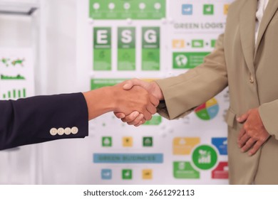 Two hands shaking in a professional setting indicating agreement collaboration and a shared vision for sustainable business practices and corporate responsibility