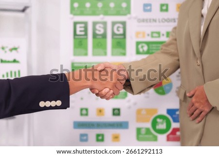 Two hands shaking in a professional setting indicating agreement collaboration and a shared vision for sustainable business practices and corporate responsibility