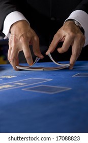 Two Hands Shuffling A Deck Of Cards In A Casino