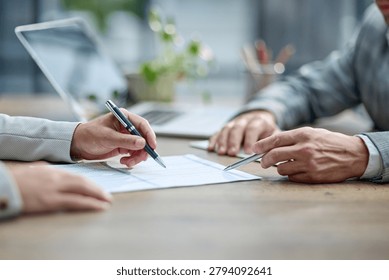 Two hands sign a document at a table. Laptop and pen rest nearby. Soft lighting suggests a professional meeting. Focus is on the act of agreement or commitment. Use for business, legal