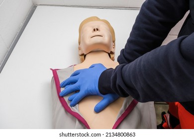 Two Hands Of SOS Volunteer Practices With A Manikin, Mannequin For CPR First Aid Of Basic Life Support Training.