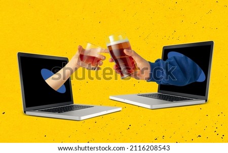 Two hands sticking out laptop screen and clinking beer and whiskey glasses each other isolated over yellow background. Concept of social gathering online, celebration, holiday. Contemporary art