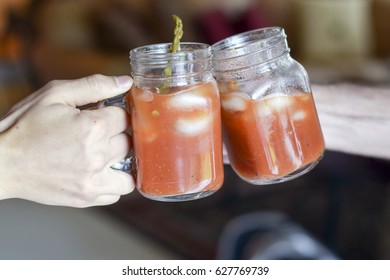 Two Hands Toasting (cheers!) With Bloody Mary Drinks