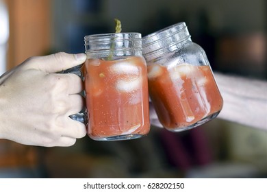 Two Hands Toasting (cheers!) With Bloody Mary Drinks