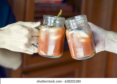 Two Hands Toasting (cheers!) With Bloody Mary Drinks