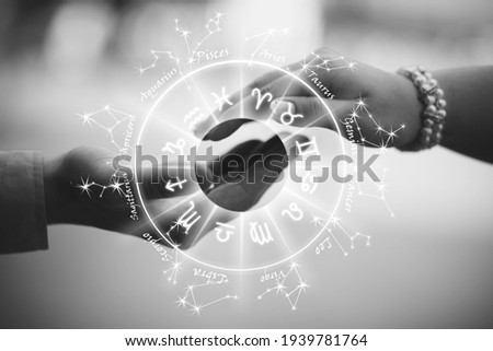 Two hands touch the background of the image zodiac