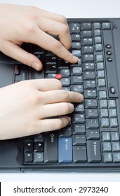 Two hands typing on a black laptop keyboard