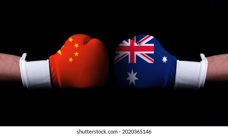 Two Hands Of Wearing Boxing Gloves With Australia And China Flag