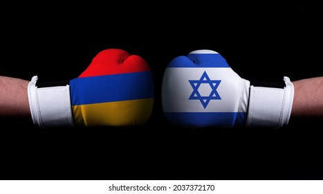 Two Hands Of Wearing Boxing Gloves With Israel And Armenia Flag. Boxing Competition Concept. Confrontation Between Two Countries