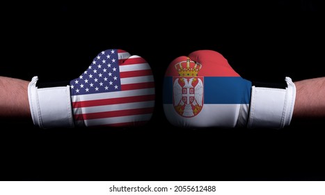 Two Hands Of Wearing Boxing Gloves With Serbia And USA Flag. Boxing Competition Concept. Confrontation Between Two Countries