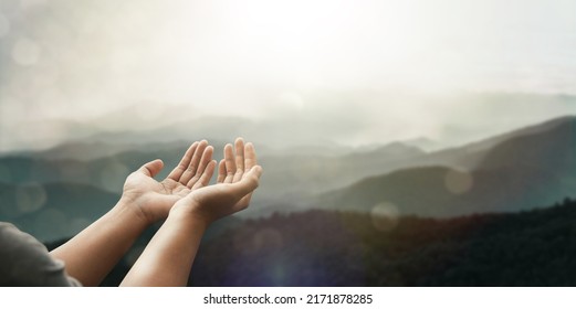 The two hands of a young man who prayed for hope from God Praise God concept. Pray, communicate. Mountain nature background. at sunrise - Shutterstock ID 2171878285