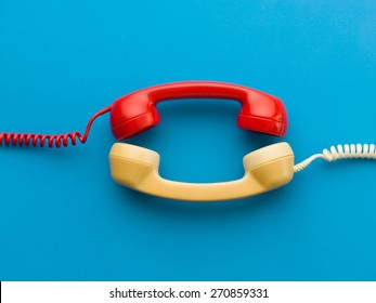 two handsets facing each other on blue background