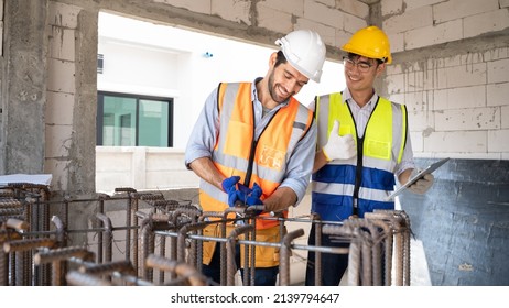 Two handsome engineers with different nationalities.Working together to steel binding wire for casting concrete structures.Multi-ethnic collaboration, Asia, Europe, Middle East,China.working safely.