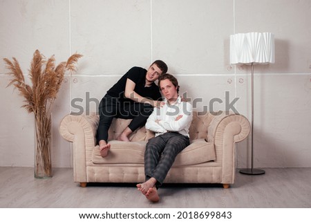 Similar – Joyful couple laughing together on a vintage sofa