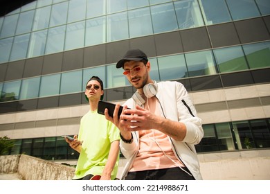 Two Handsome Male Friends Are Both Looking Something On The Phone