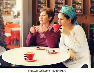 Two Happy 45 Years Old Woman Sitting In The City Cafe