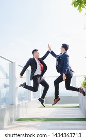 Two Happy Adult Business Men High Fiving