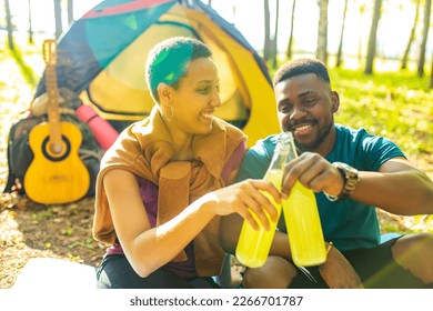 two happy african american people in love spending time outdoors in camp - Powered by Shutterstock