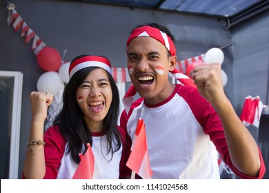 two happy asian people celebrating indonesia independence day